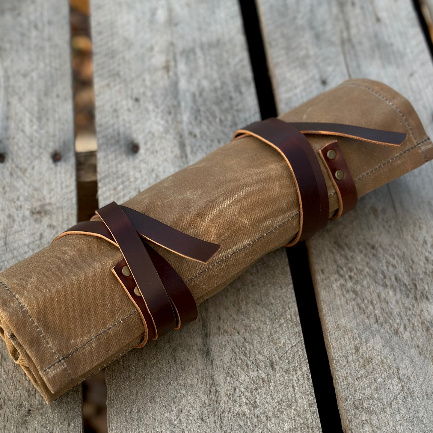 Waxed canvas knife and tool roll with leather straps, perfect for storing tools and knives up to 11 inches long.