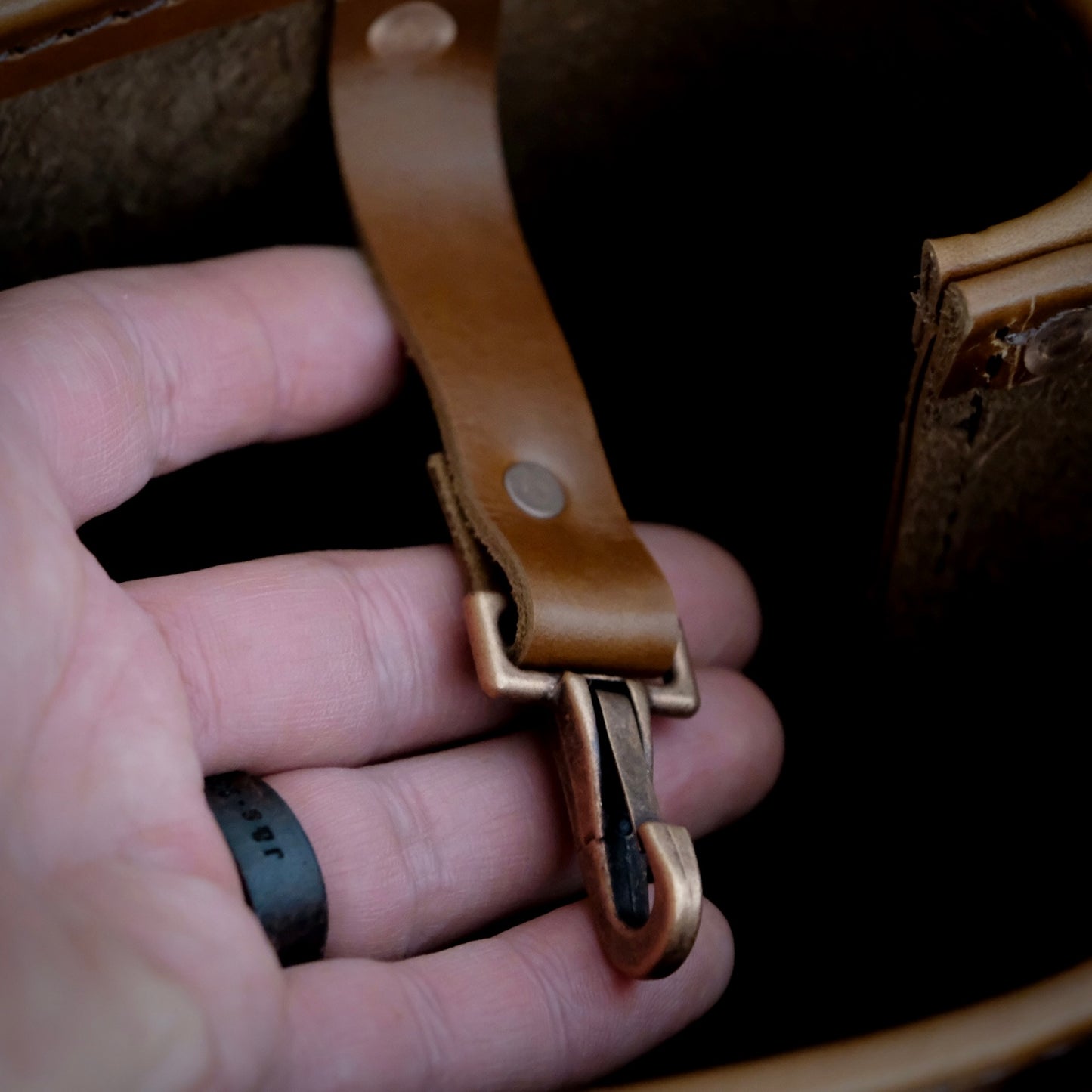 Close-up of a brass key clip on The Hill Country Tote leather bag, showcasing the premium craftsmanship.