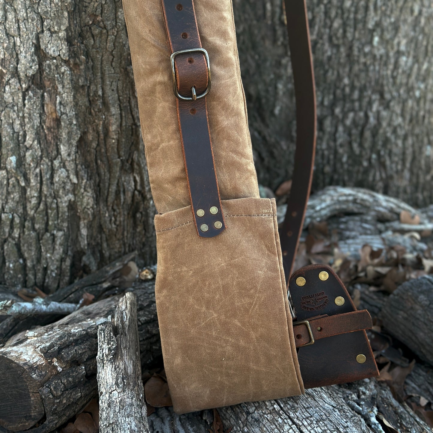 Heritage Edition Woodsman Axe Saw Sling in waxed canvas with leather accents, perfect for carrying tools.
