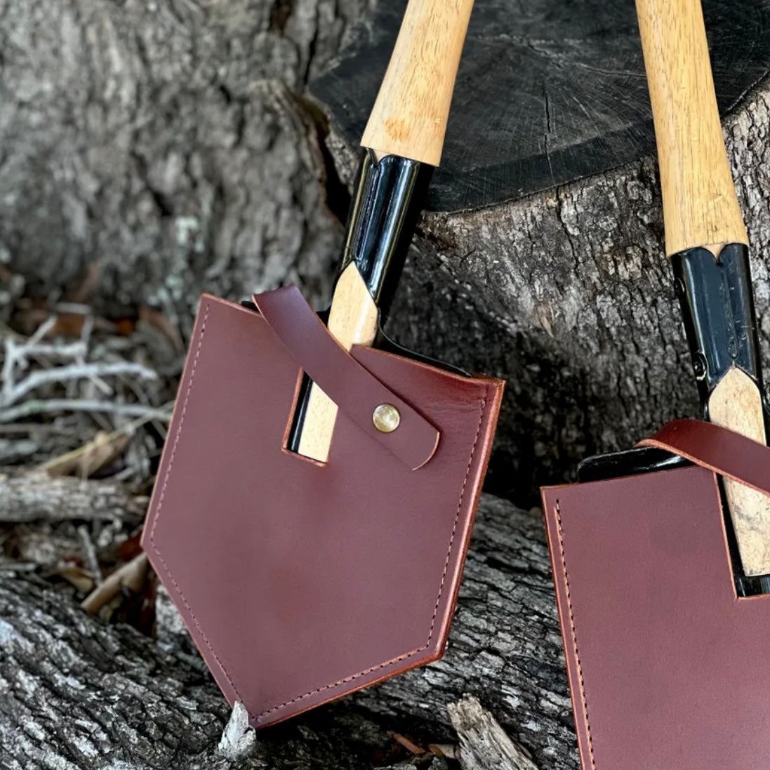 Handmade shovel mask made from premium leather, showcasing durability and craftsmanship on a rustic wooden background.