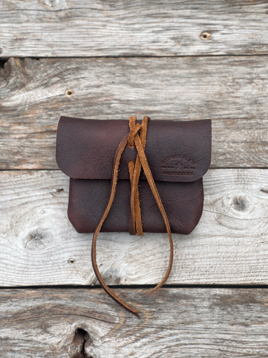 Small leather field pouch with lace tie, ideal for carrying rifle cartridges and small items.