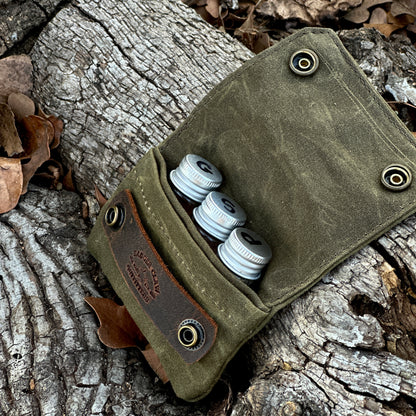 Small seasoning kit with three glass jars in a waxed canvas holder, perfect for spices and seasonings.